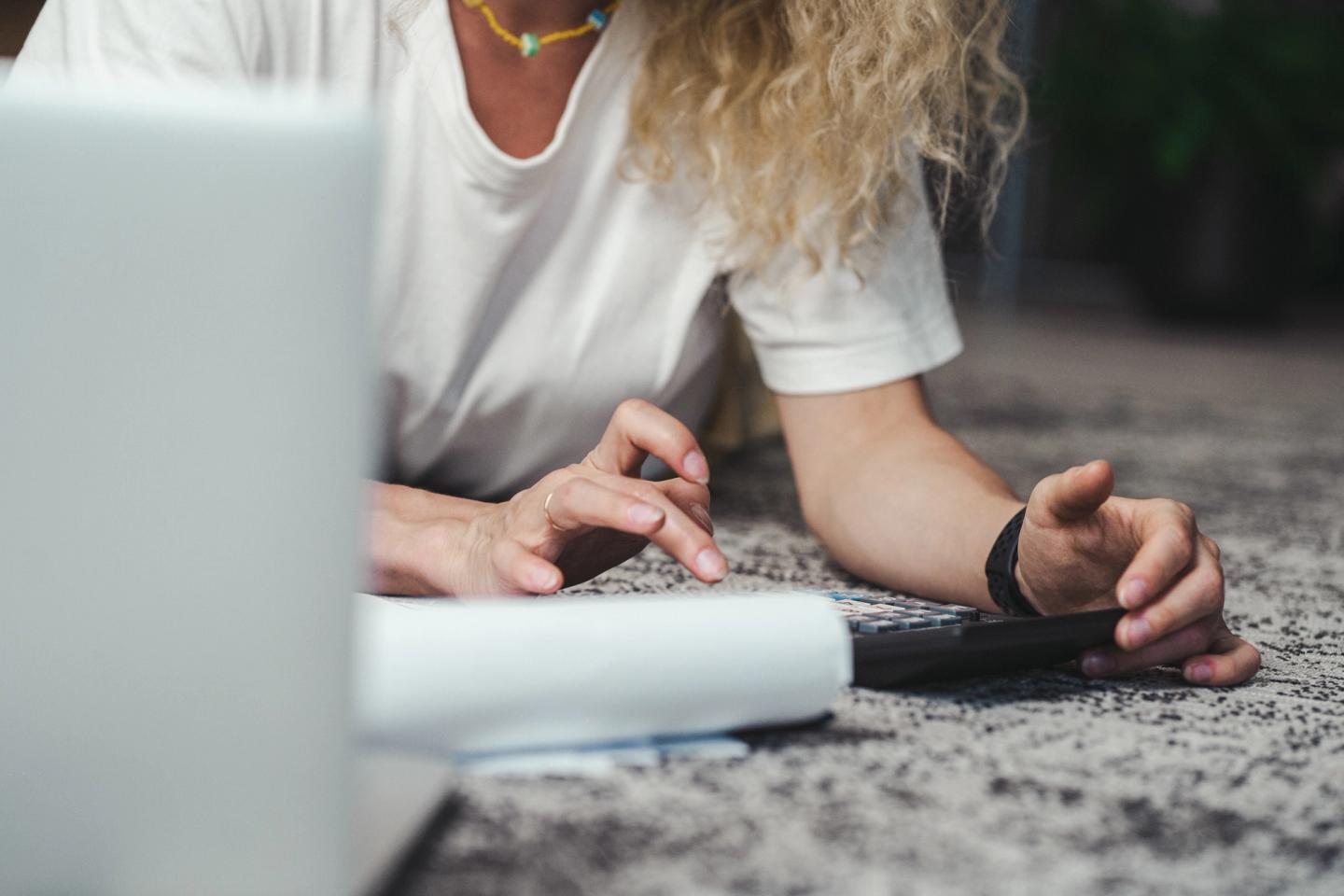 woman counting bills using the calculator