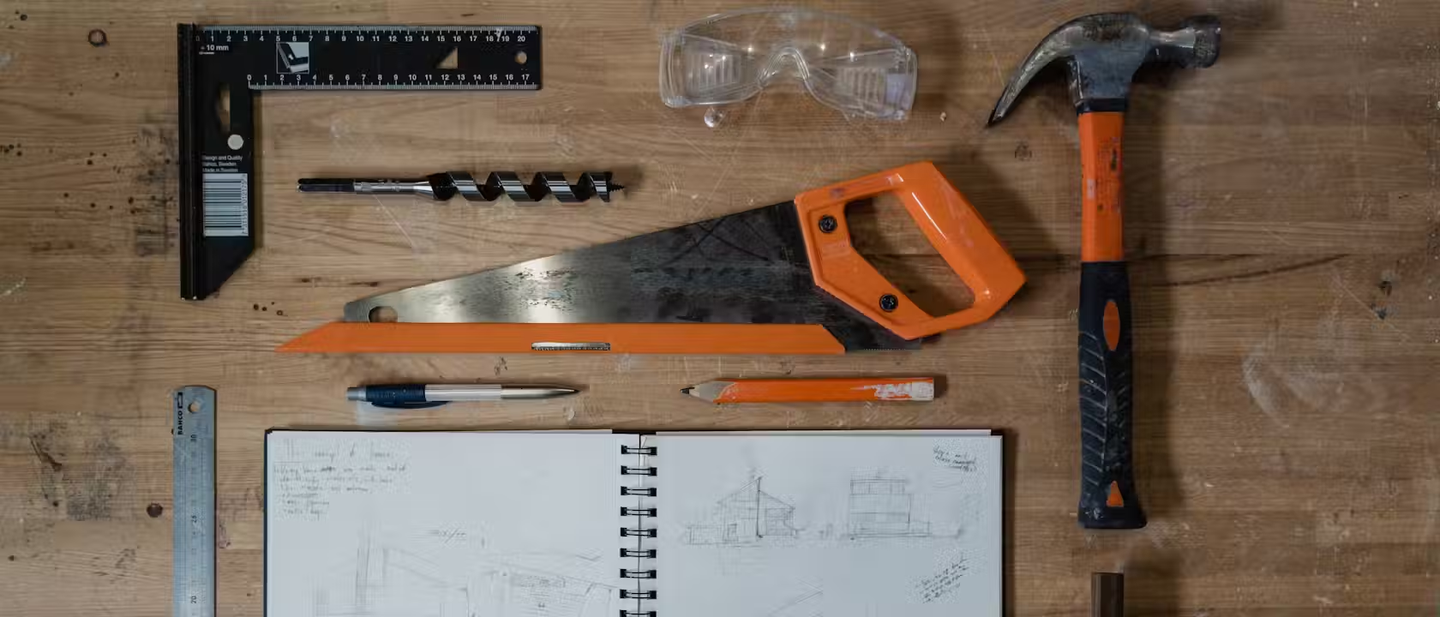 A selection of woodwork tools laid out on a work bench.