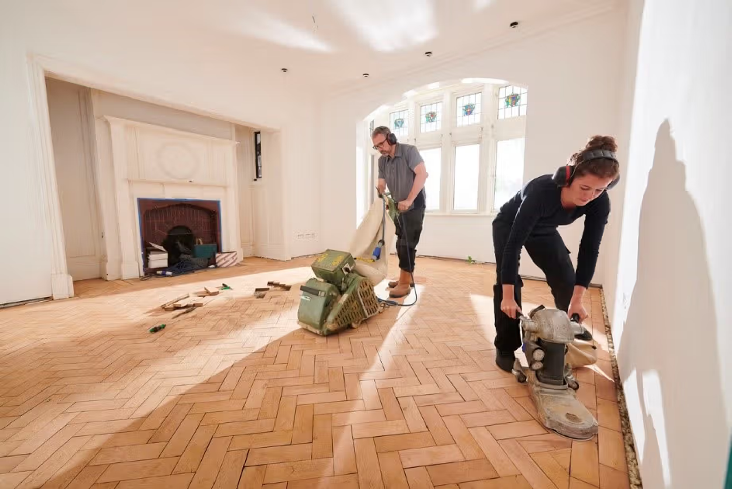 living room floor being sanded