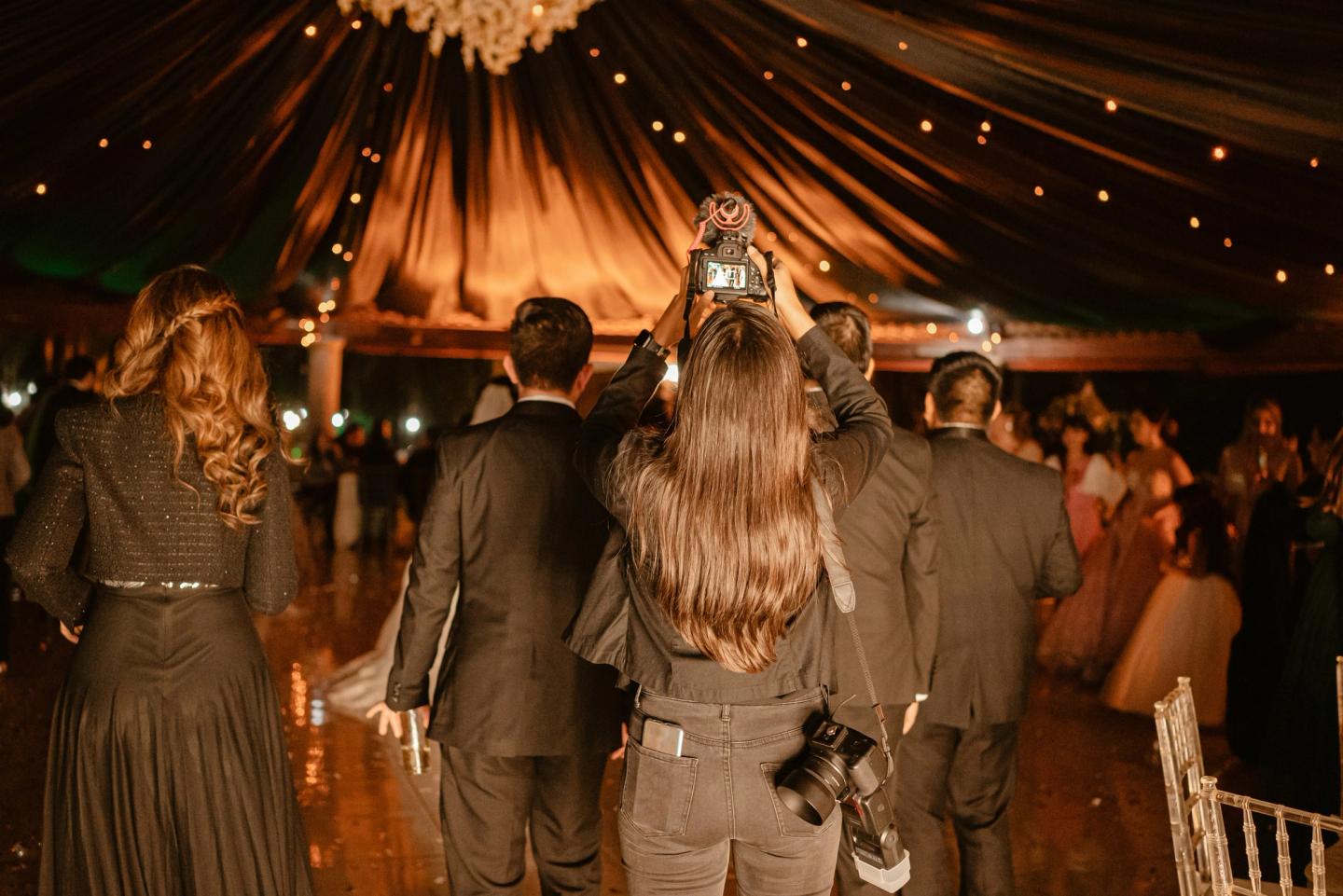 photographer taking pictures at wedding in a marquee