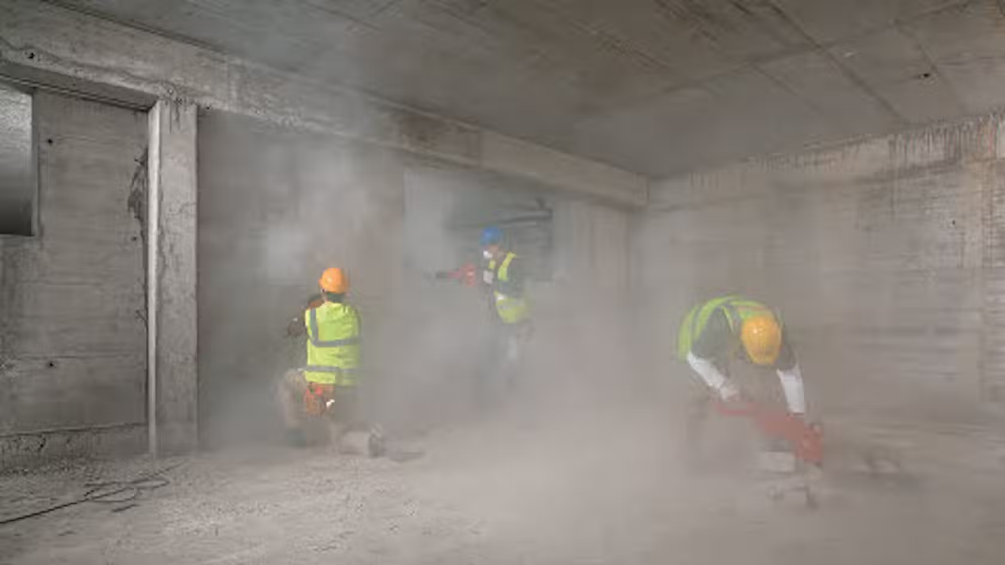 Construction worker on site using electric breakers.
