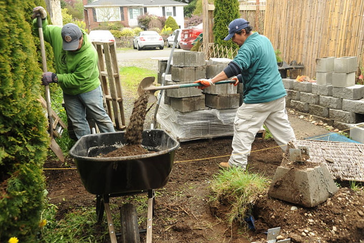two gardeners working on the garden lawn