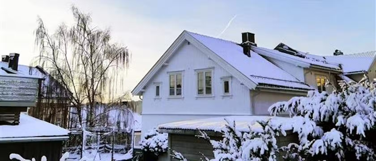 A home covered in snow on a winter's day.