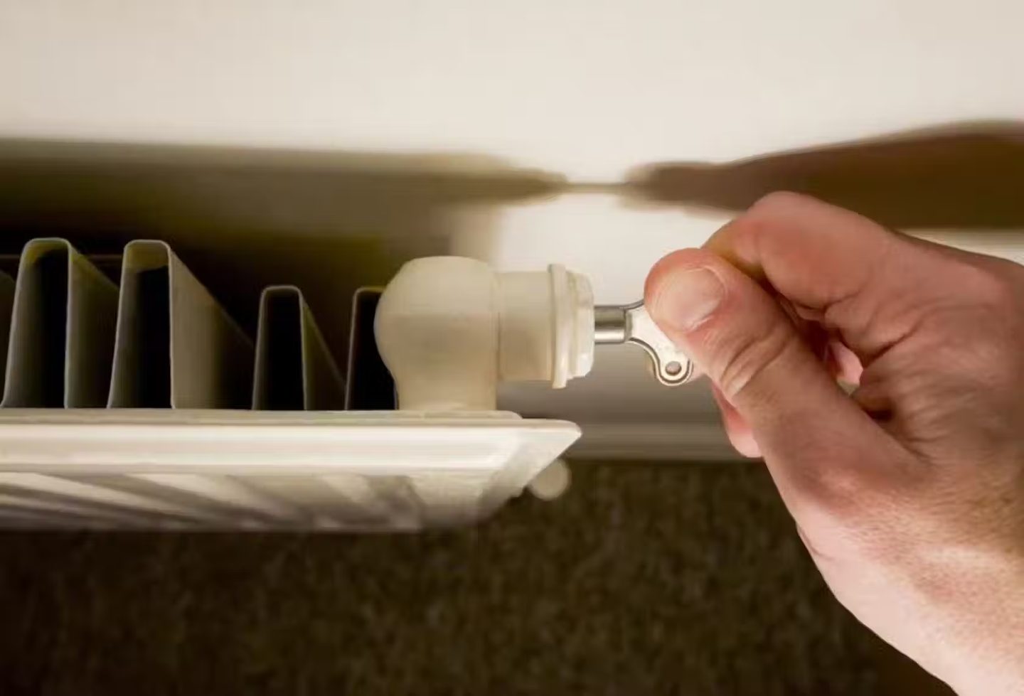 Someone using an Allen key to bleed their radiator.