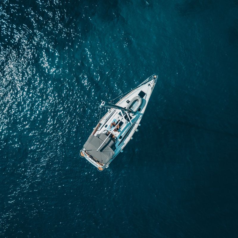 High Angle Photo of White Boat on Body of Water