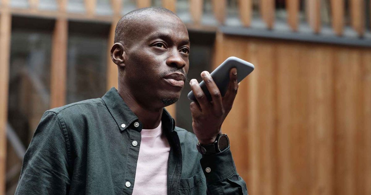 man using his smartphone for voice commands