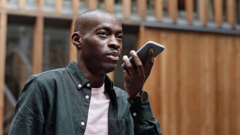 man using his smartphone for voice commands