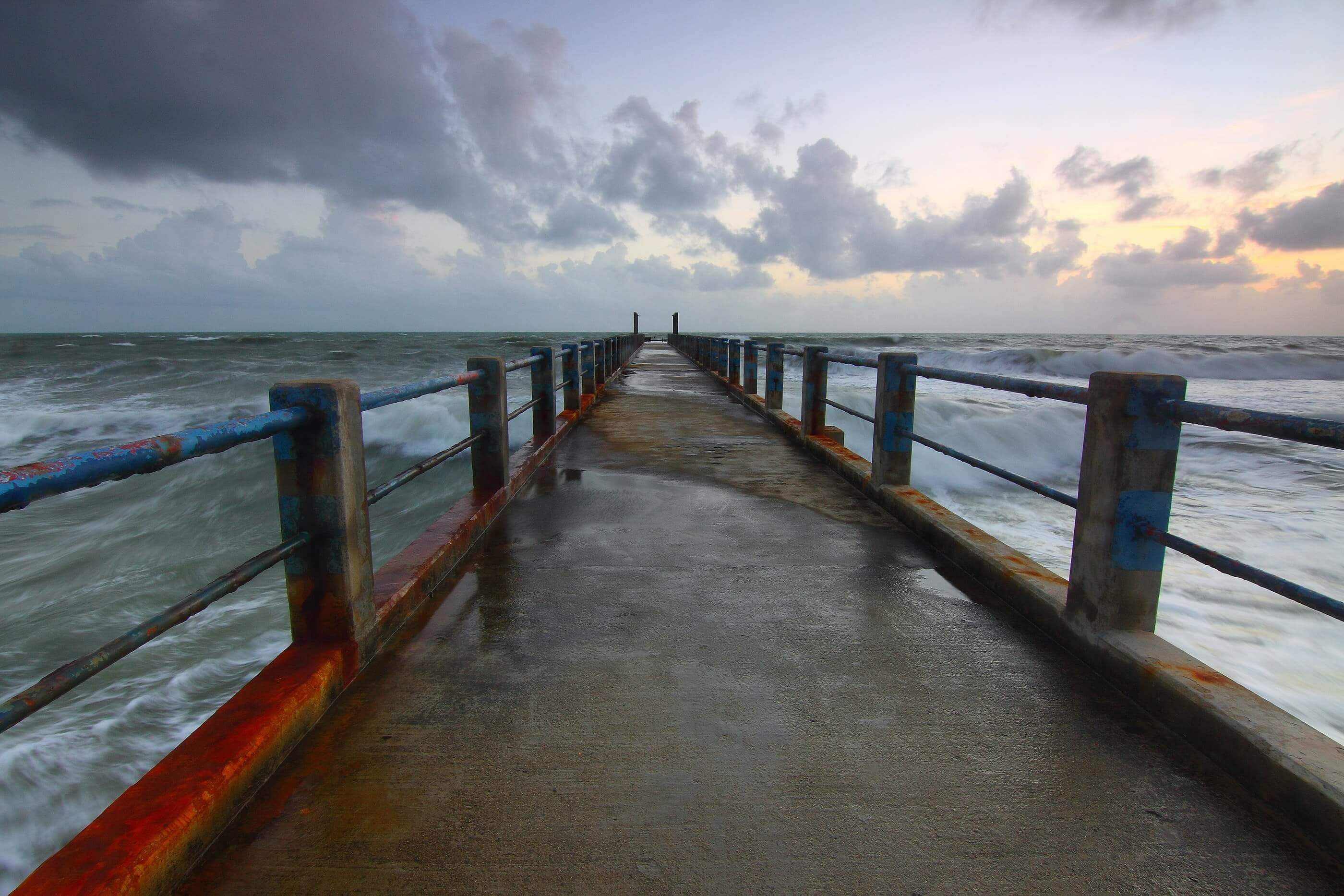 A pier walkway overtop of an ocean