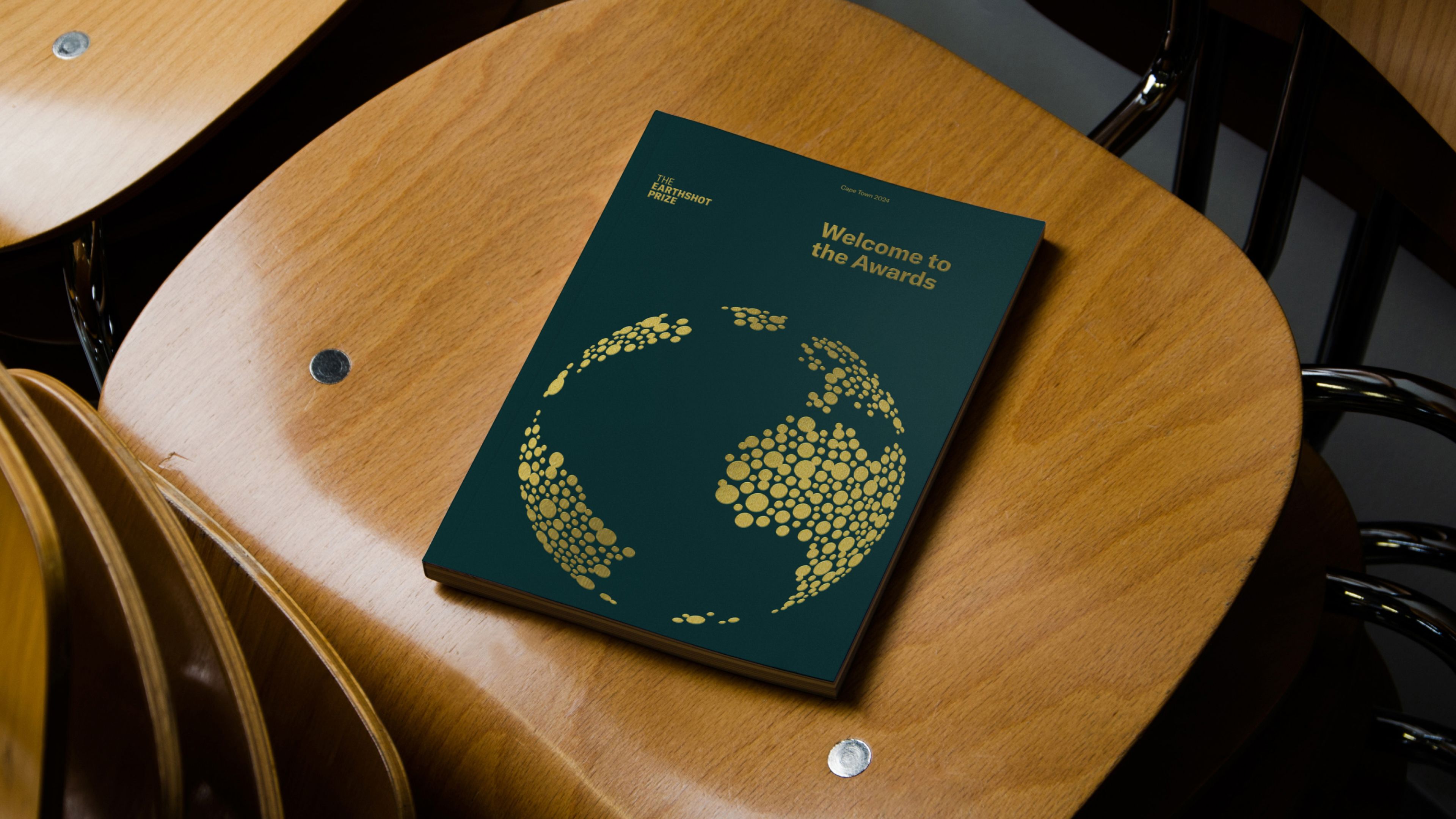 A image of The Earthshot Prize branding as a printed program and book for the event in Cape Town