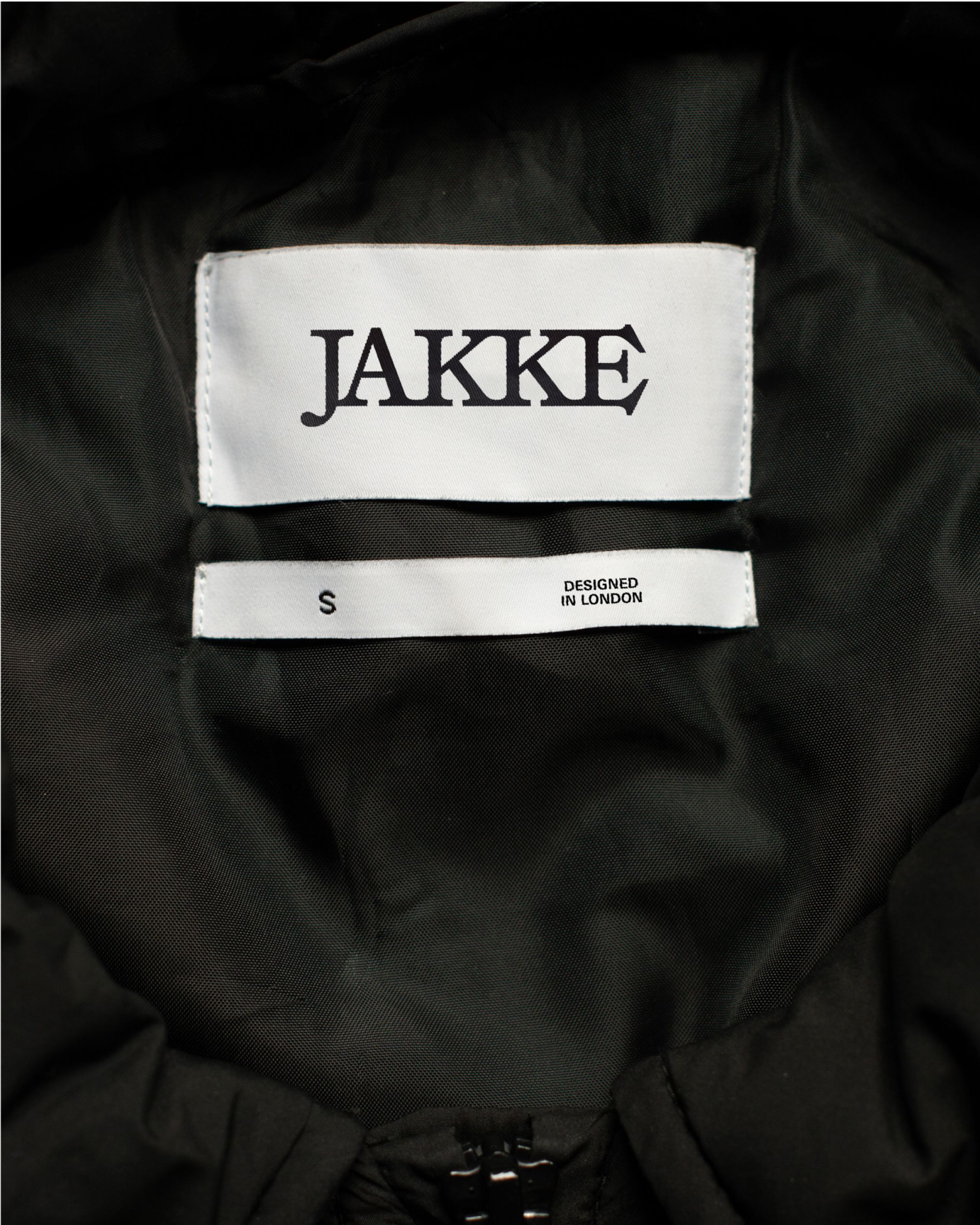 An image of Jake womenswear fashion brand showing the label and logo in a jacket