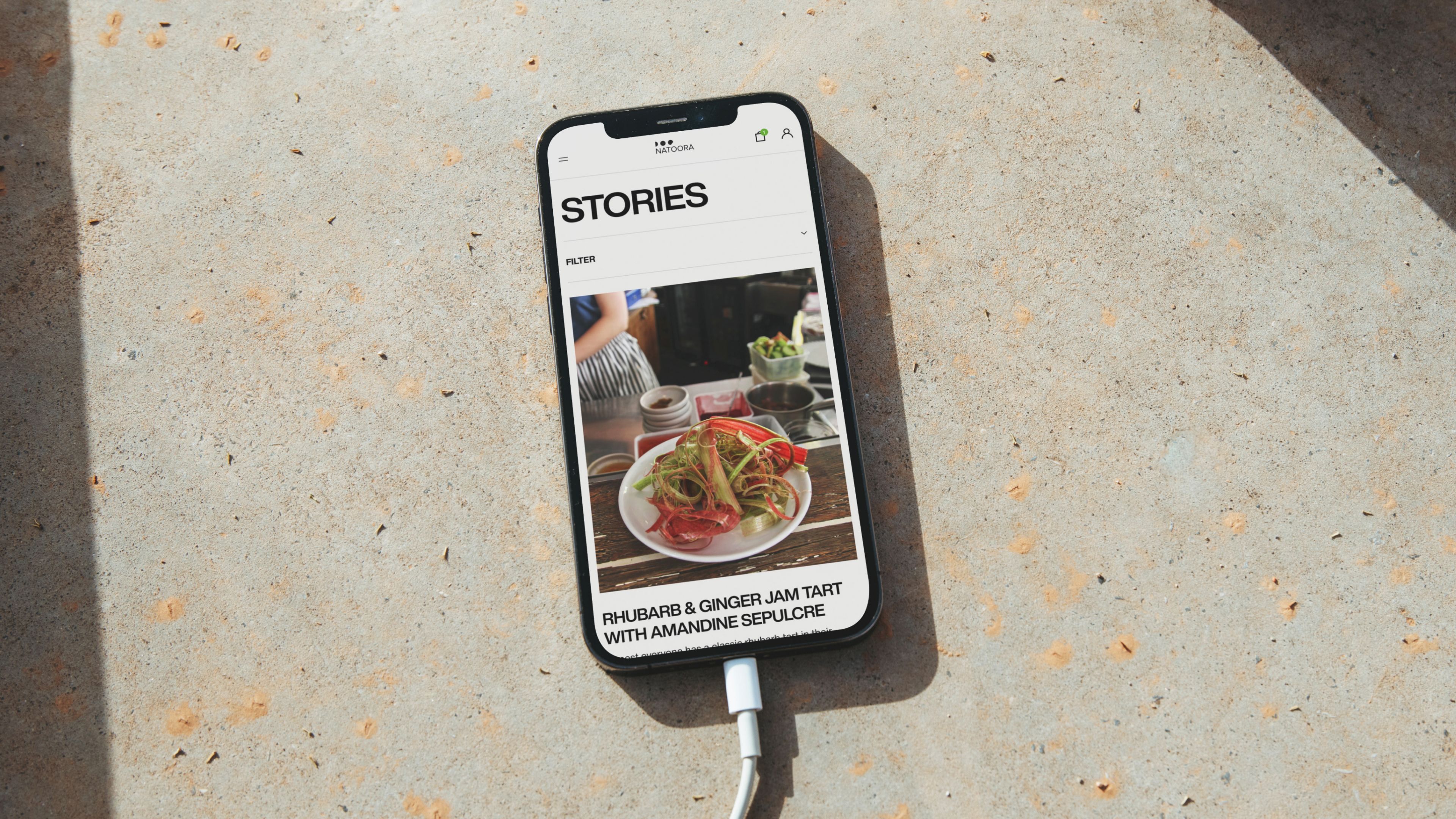 An image of Natoora digital website and e-commerce experience in a phone