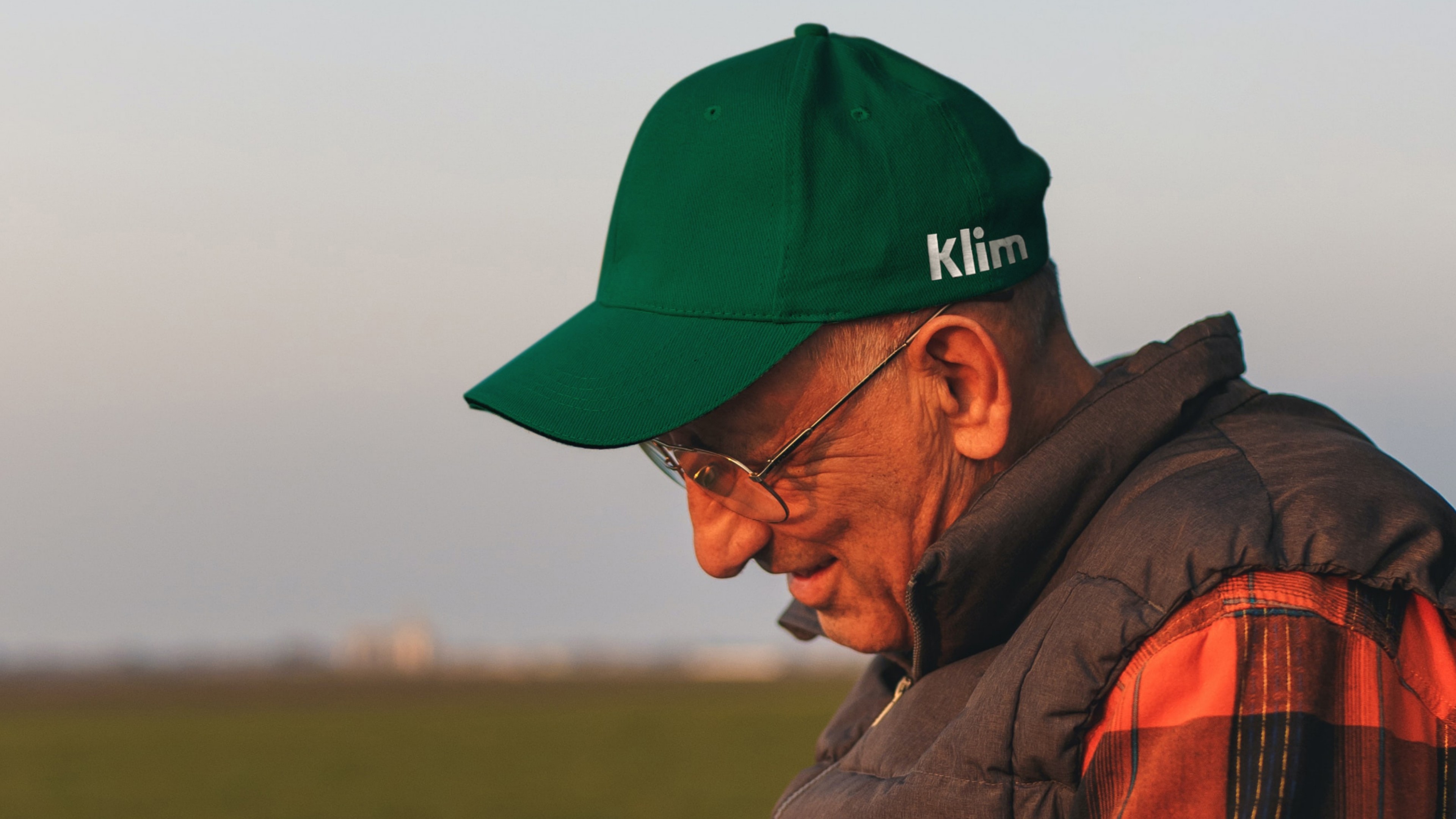 An image of Klim branding on a hat on a photographer showing a farmer