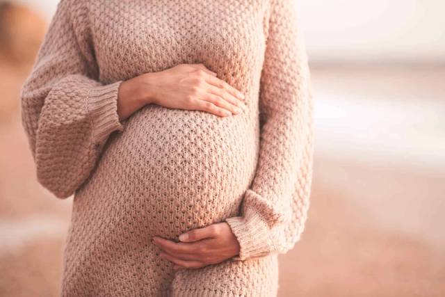 Gros plan sur le ventre d’une femme enceinte.
