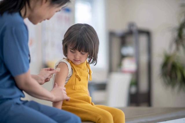 Médecin administrant une injection du vaccin Repevax à un patient lors d'une consultation
