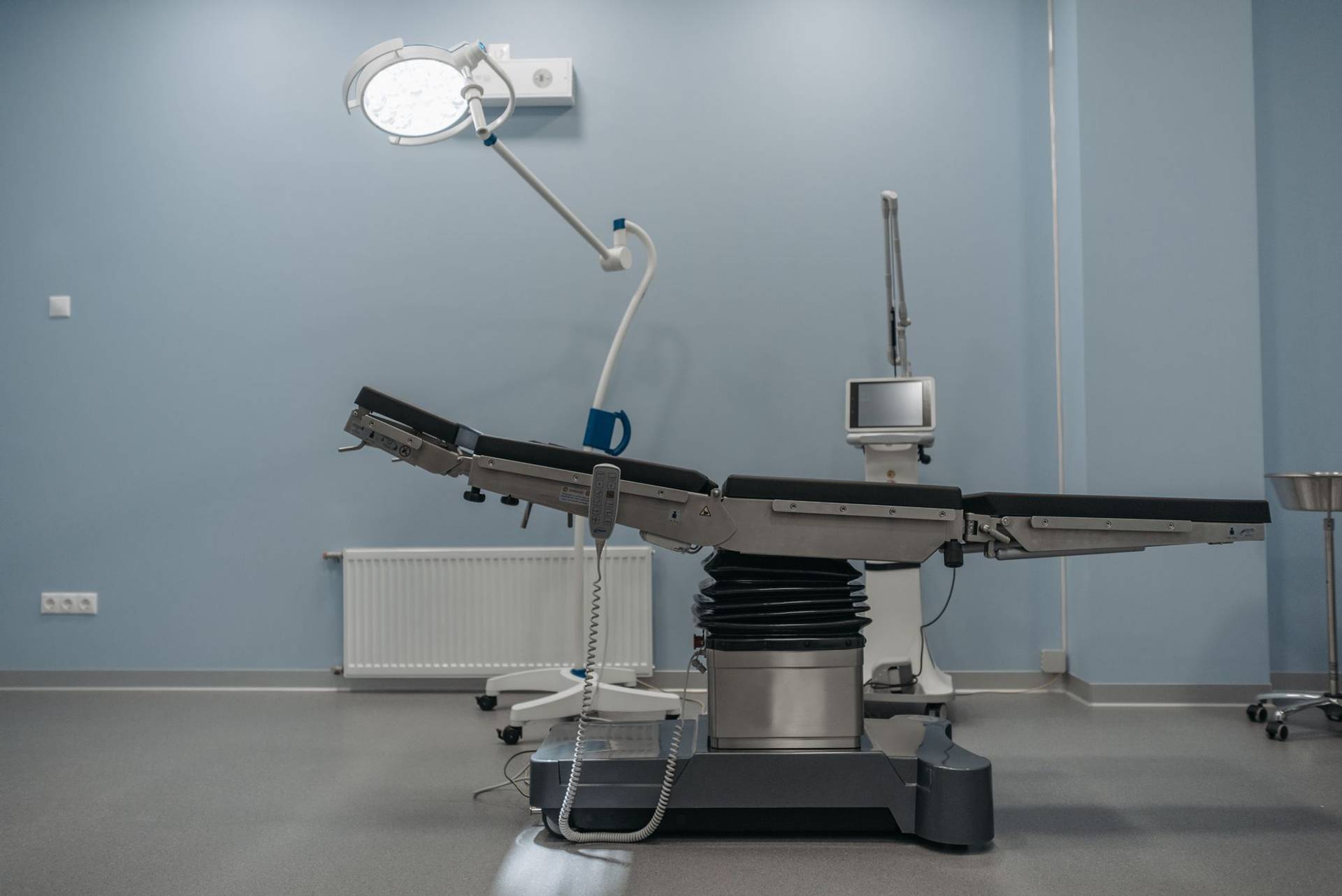 Table et éclairage dans une salle d’opération vide.