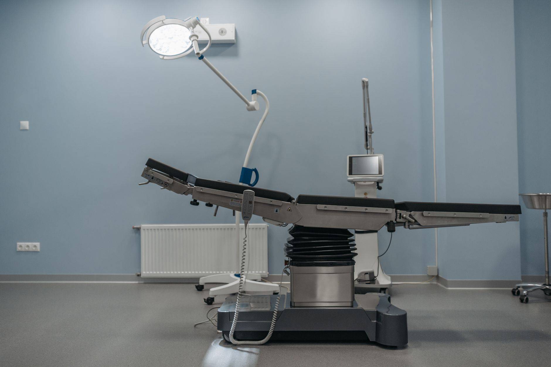 Table et éclairage dans une salle d’opération vide.
