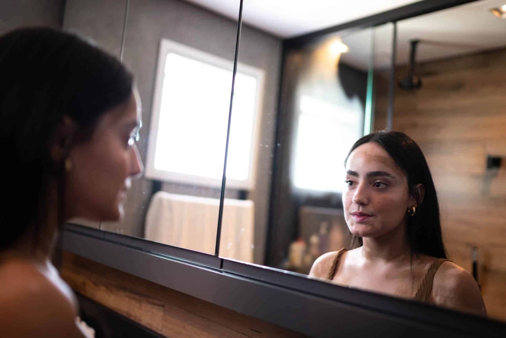 Femme se regardant dans un miroir.