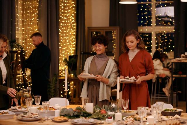 Chaleureux rassemblement de Noël en famille et entre amis autour d'une table à manger décorée festivement
