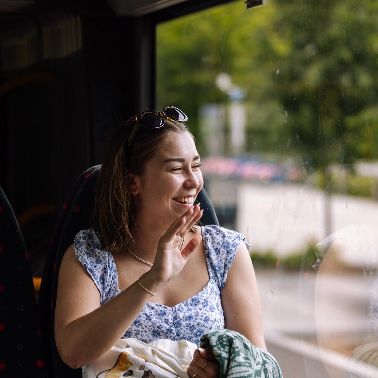 Woman looking out the window of the bus