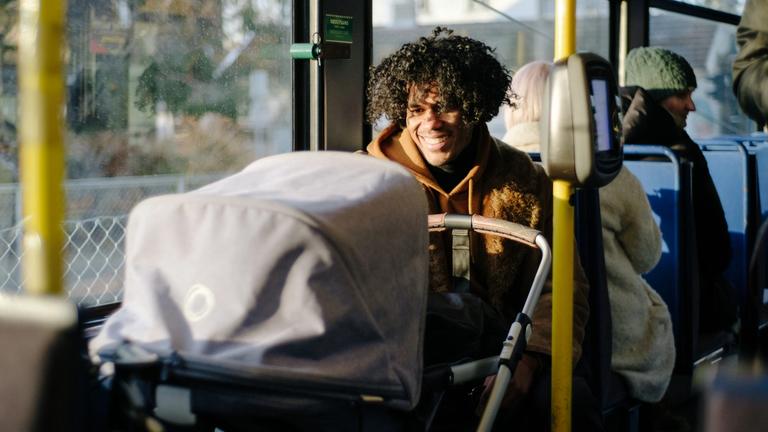Man with a baby on the tram