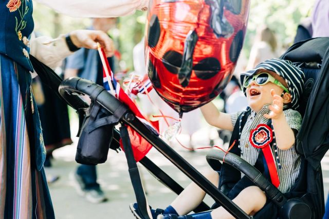 Picture of a child in a stroller celebrating May 17th