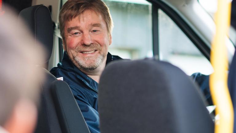 Close up of a driver who opens the door for a passanger