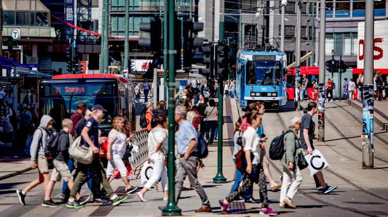 People in the city scape surrounded by public transport