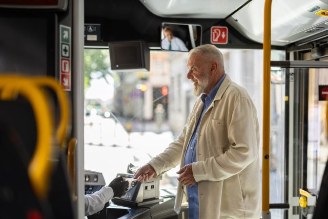 Eldre mann går på bussen 