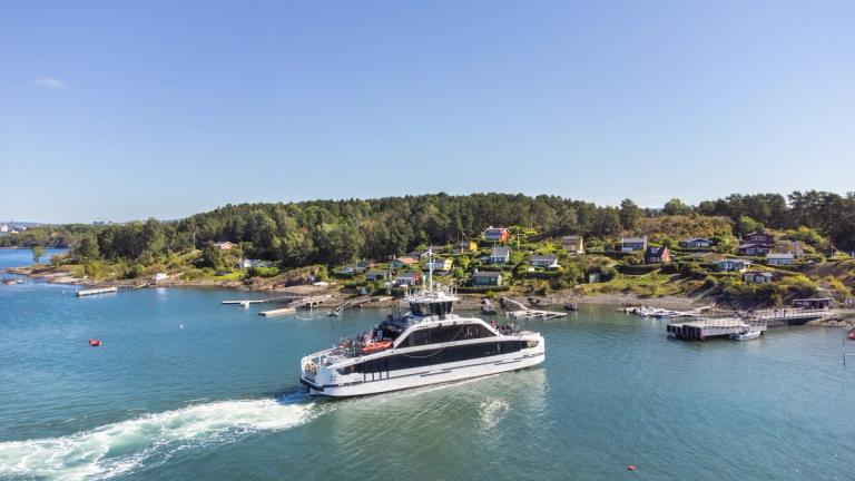 One of Ruters boats is arriving at an island in the Oslo fjord