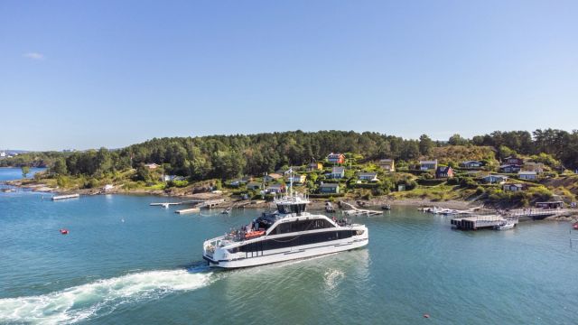 One of Ruters boats is arriving at an island in the Oslo fjord