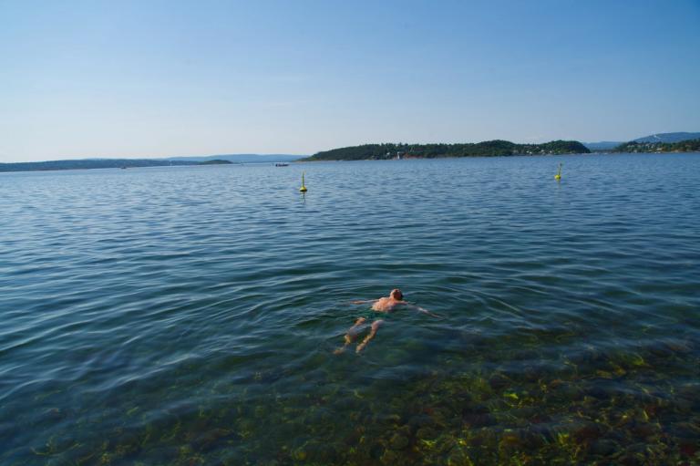 A young man is taking a bath in the ocean