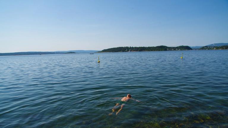 A young man is taking a bath in the ocean