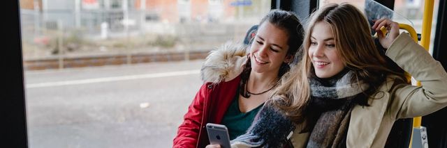 Picture of smiling teenage girls on a bus