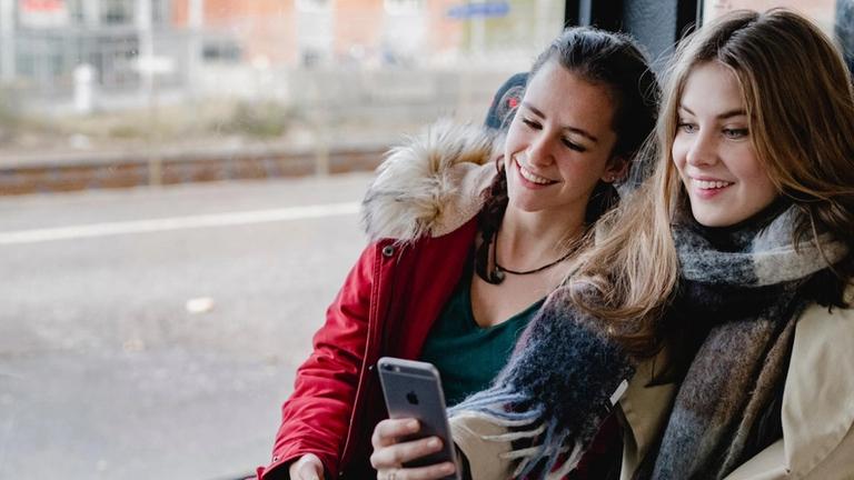 Picture of smiling teenage girls on a bus