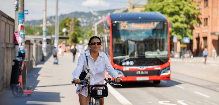 Woman riding an Oslo city bike in the city