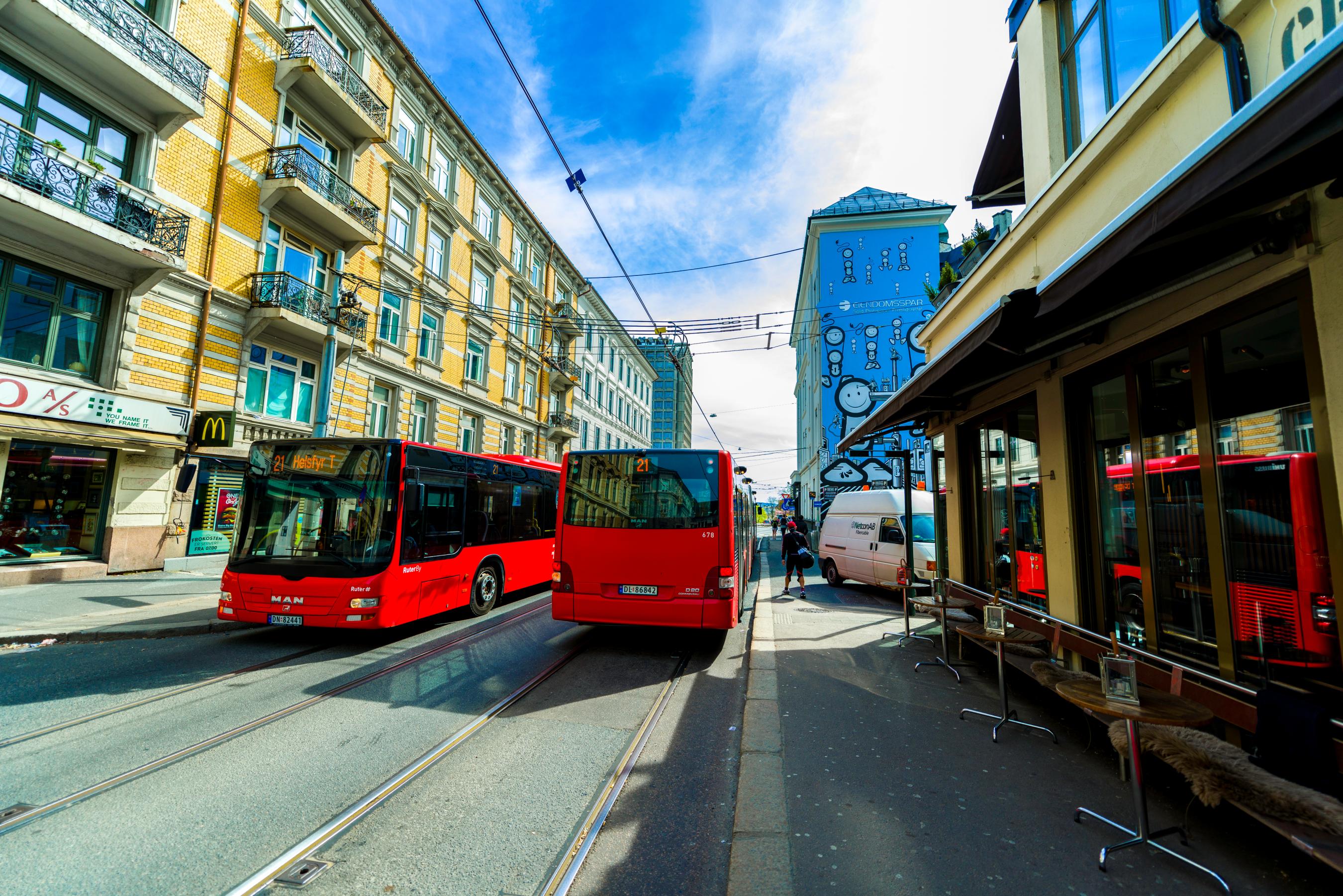 Two red buses driving past each other
