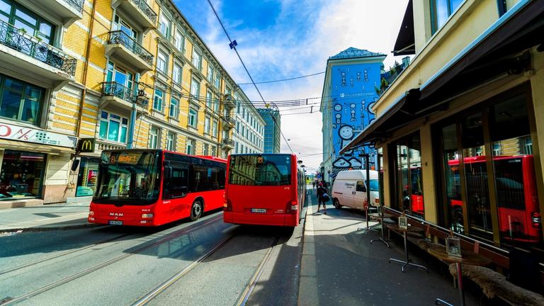 Two red buses driving past each other