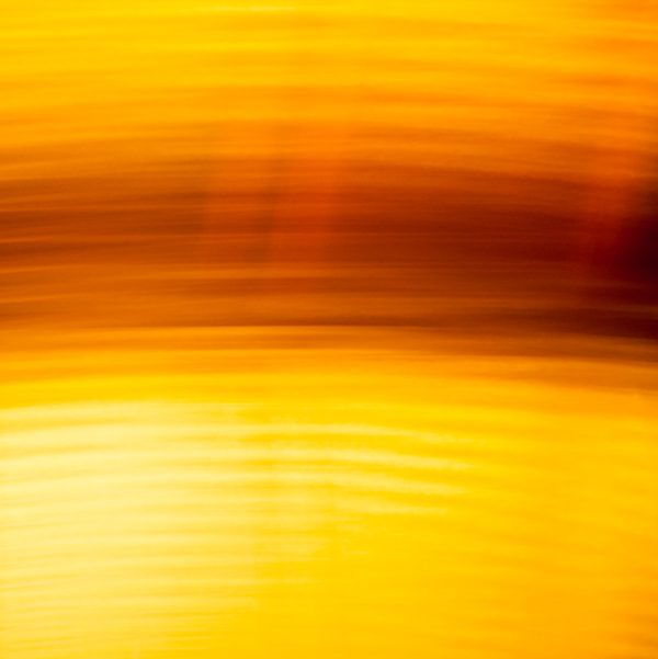 Soft horizontal streaks of gold, amber and deep orange, blurred so that no edge is sharp.