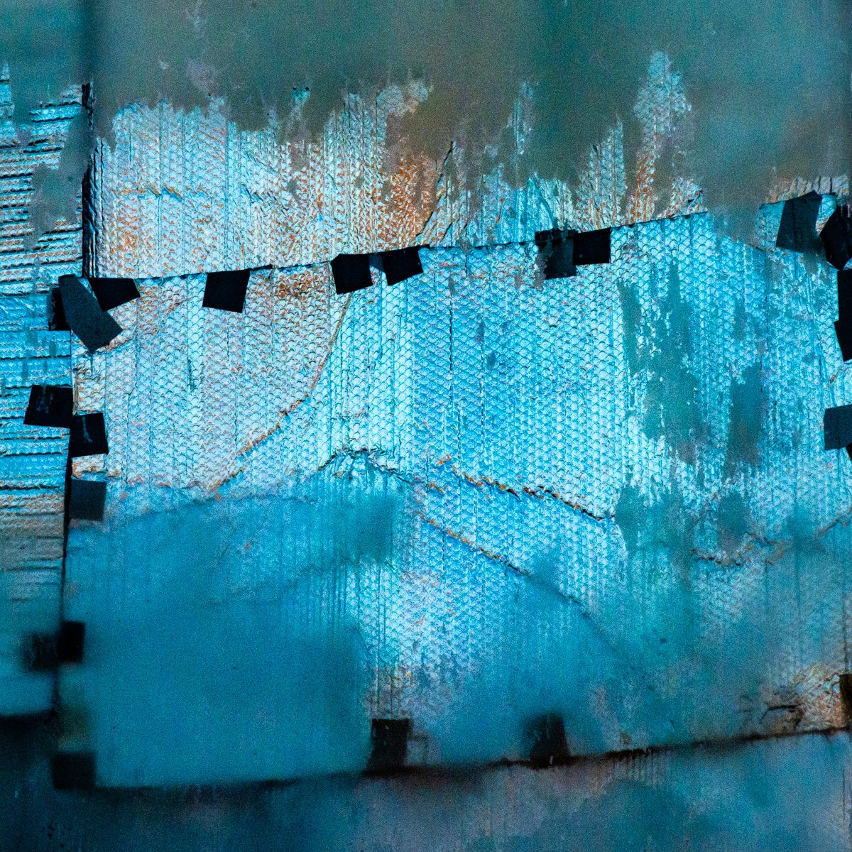 Pale turquoise textured panels with torn, peeling edges, held by small dark squares along a jagged seam.