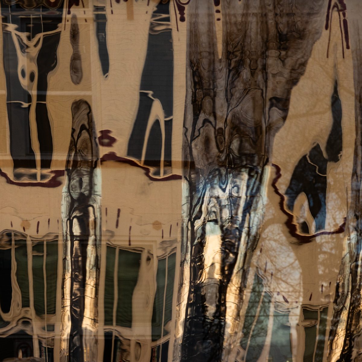 Tall cream and charcoal forms waver and stretch, edged with thin dark red lines.