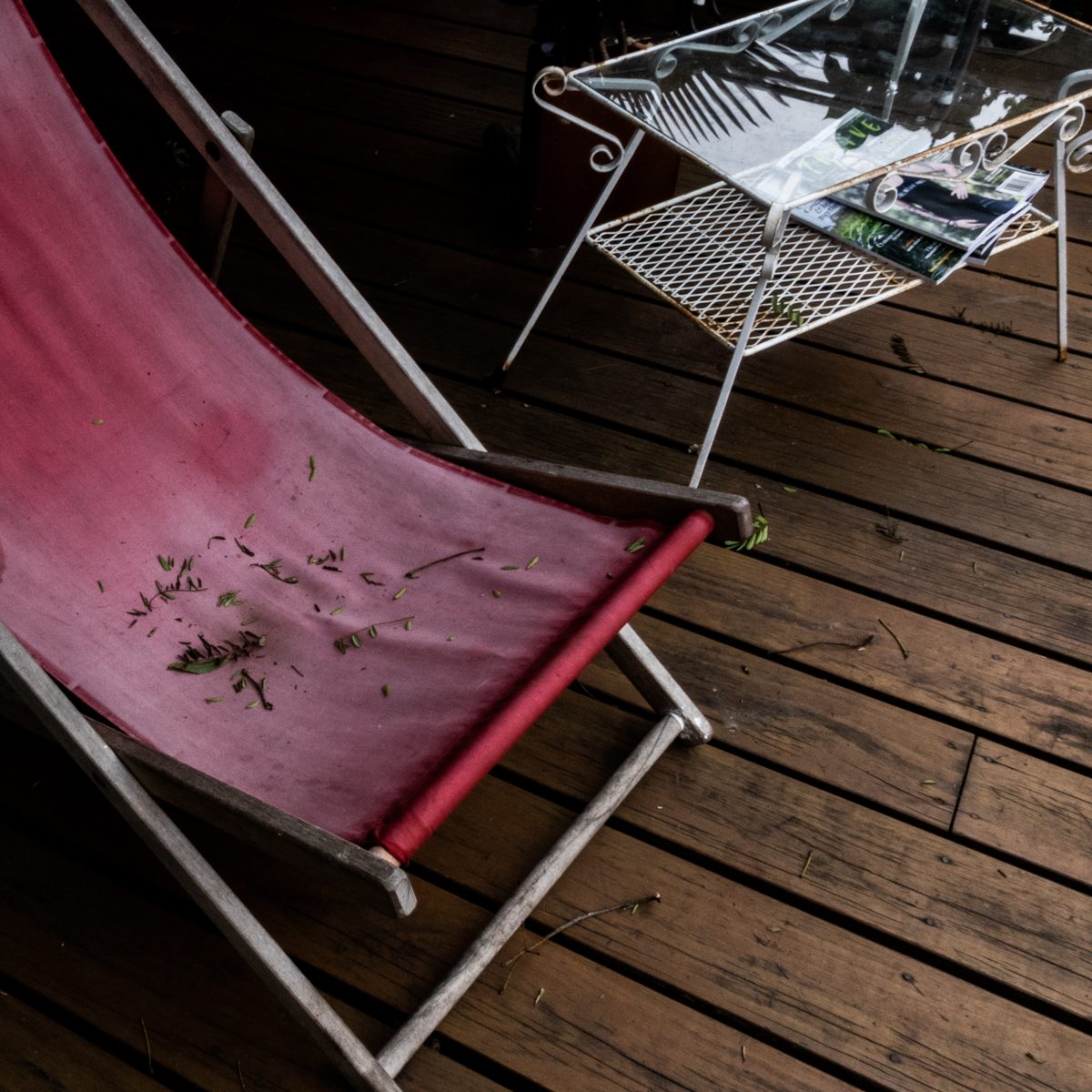 Best in Show at the Colorado Photographic Arts Center's 60th Annual Members' Show, 2023, and now held in CPAC's collection. A faded pink sling leans across warm brown boards scattered with green flecks.