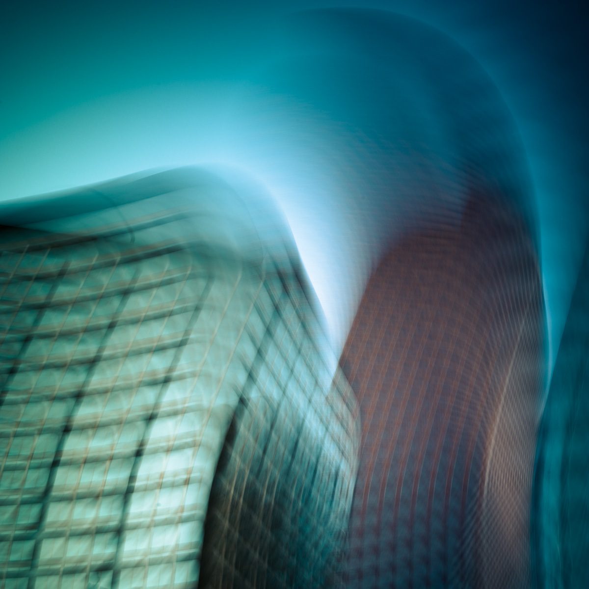 Blurred teal and green forms bending sharply to the right as if caught mid-sway, with a faint grid showing through.