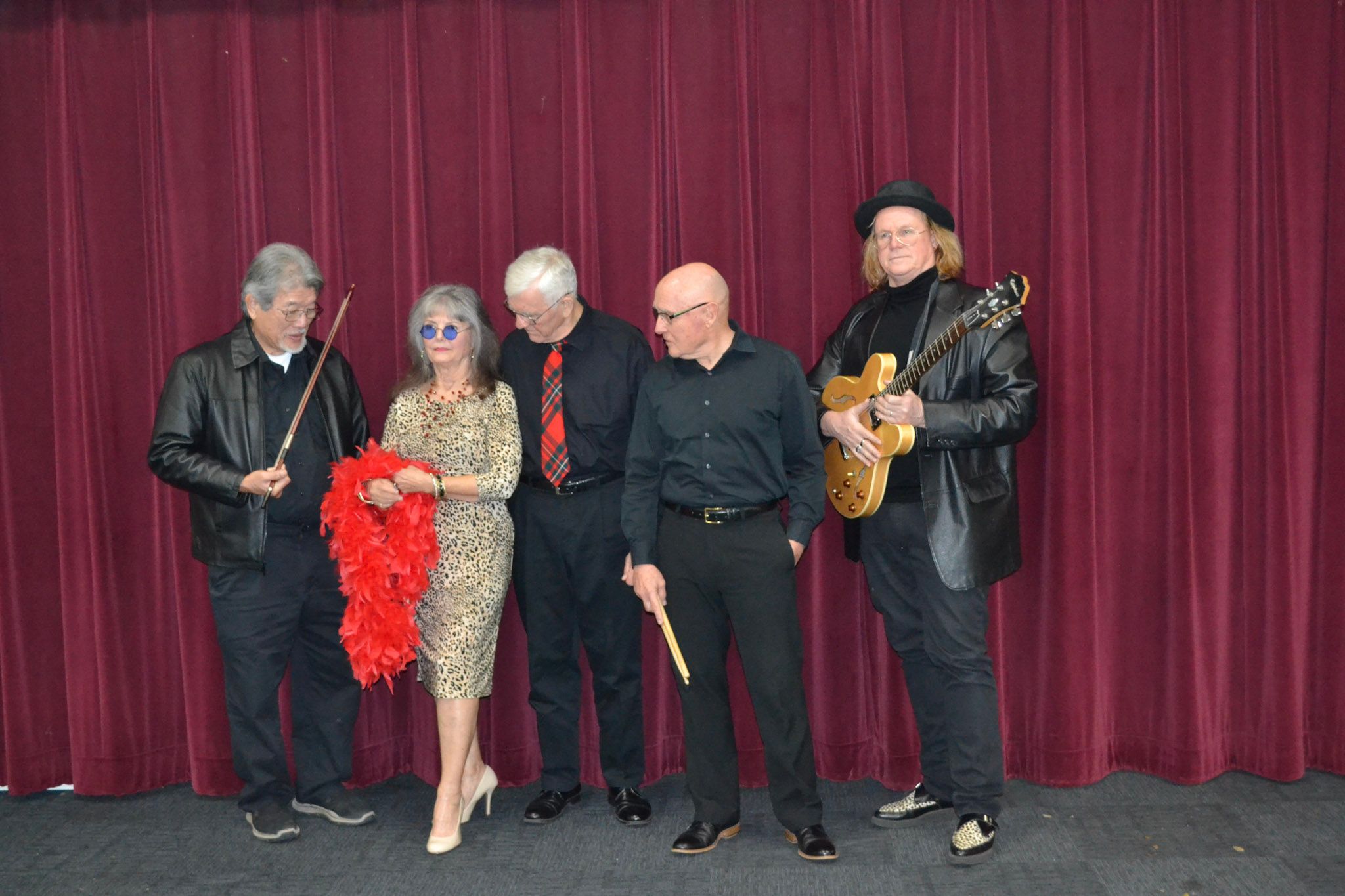 The SwingMasters rhythm section and vocalist posing together backstage