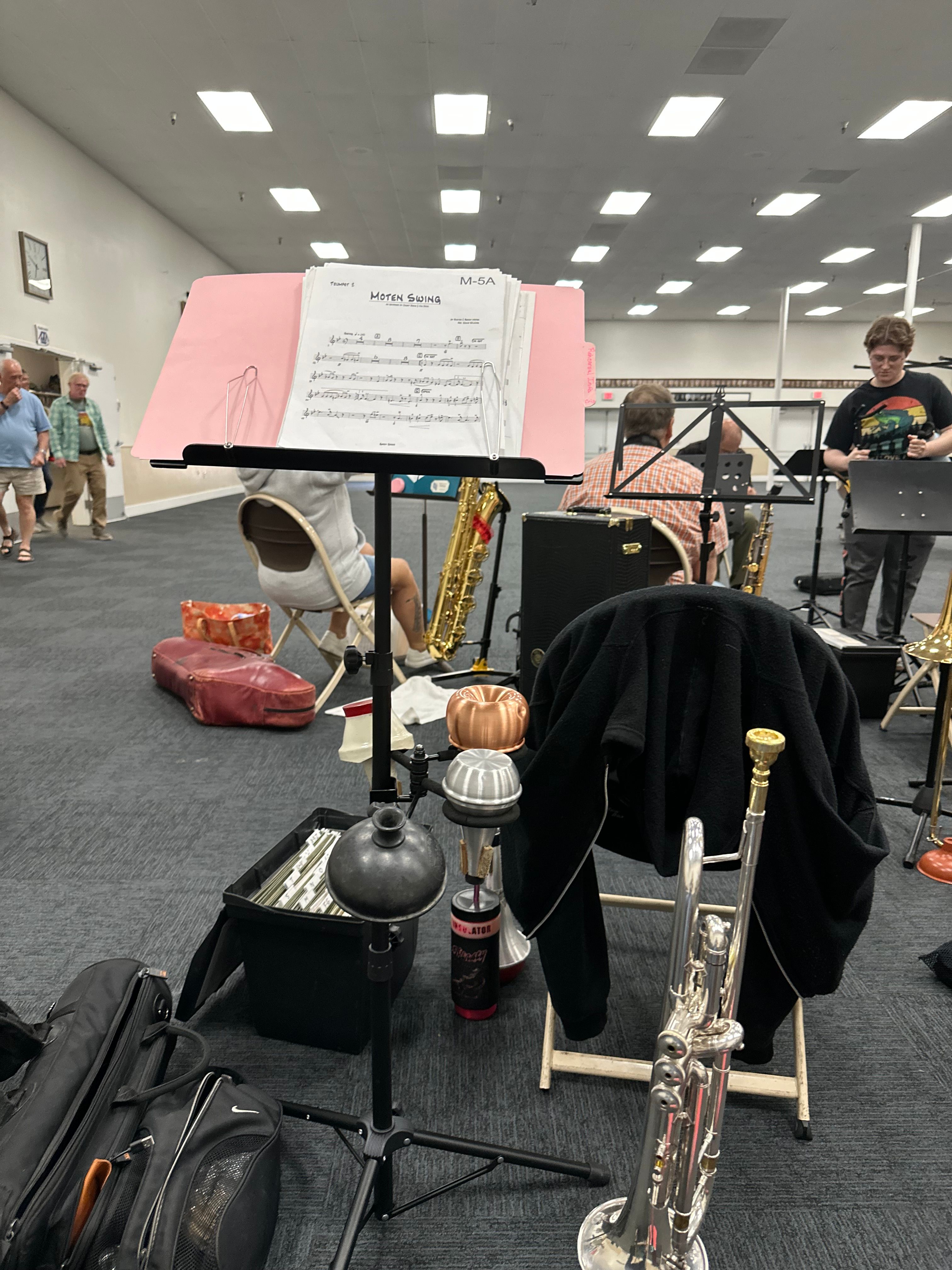 Instruments, sheet music, and gear backstage between sets