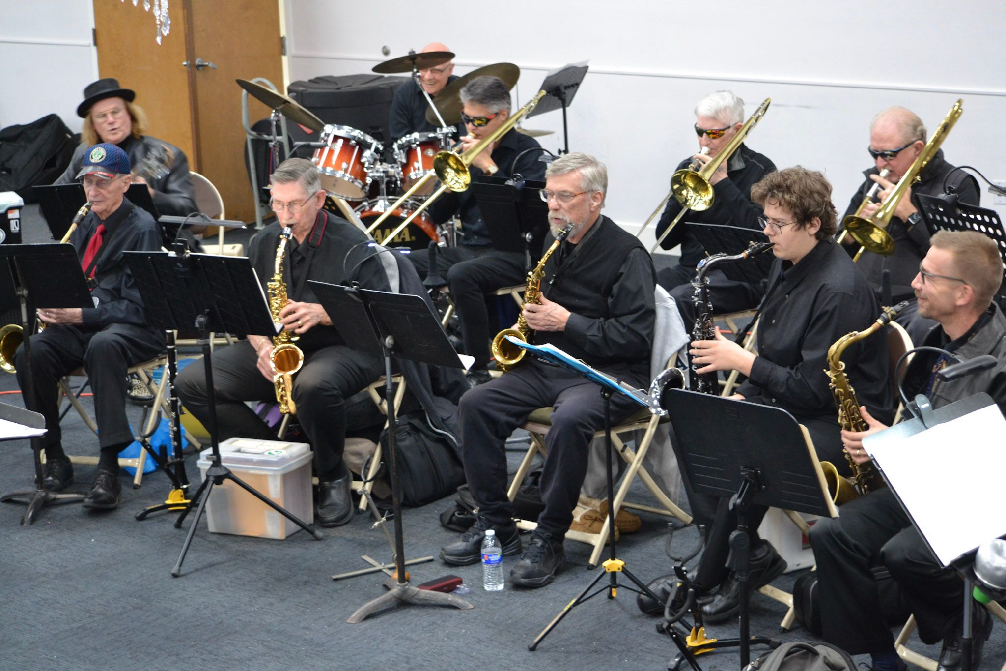 The saxophone and trombone sections performing together on stage