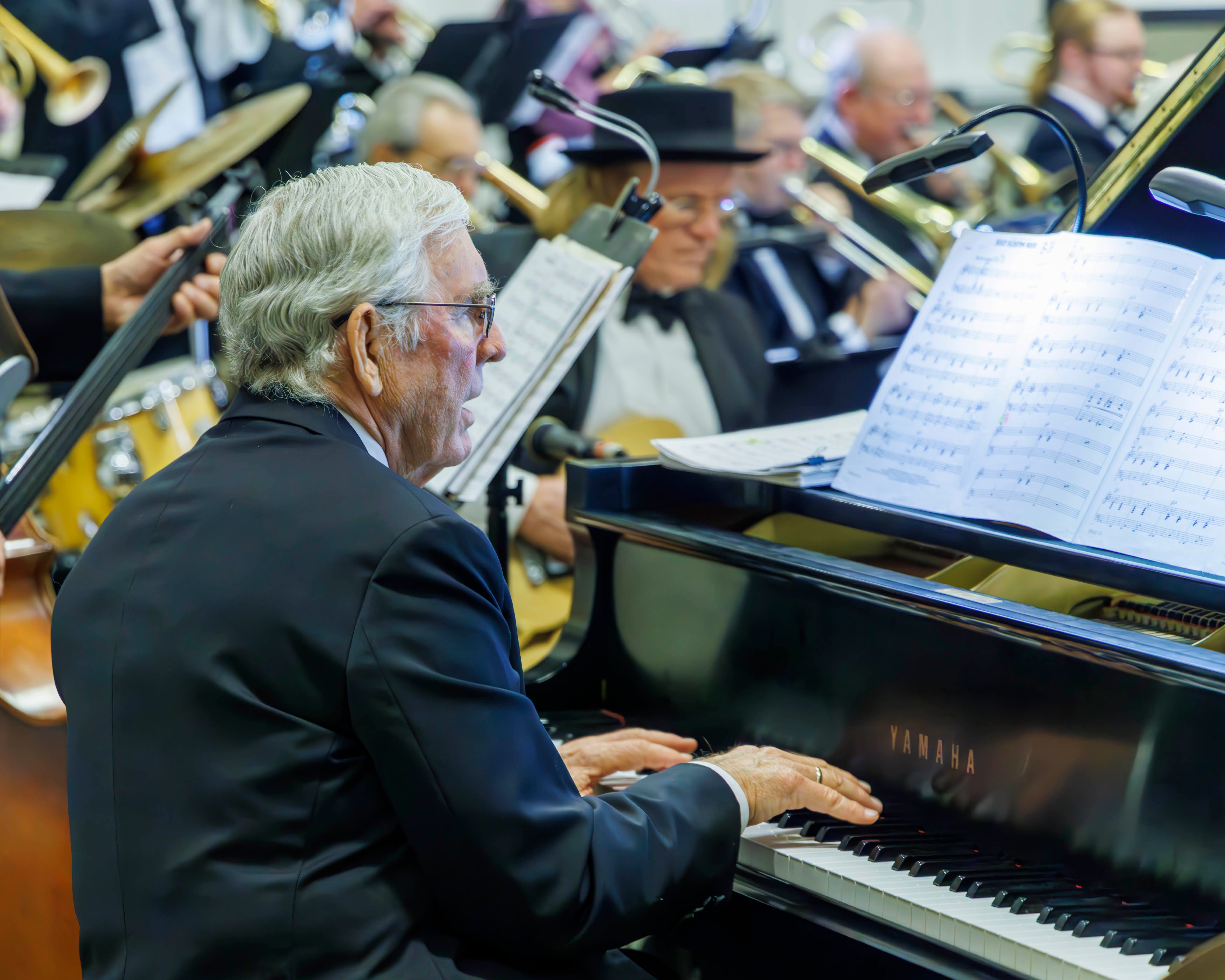 Musical Director Mark Toffelmier playing piano during a SwingMasters performance