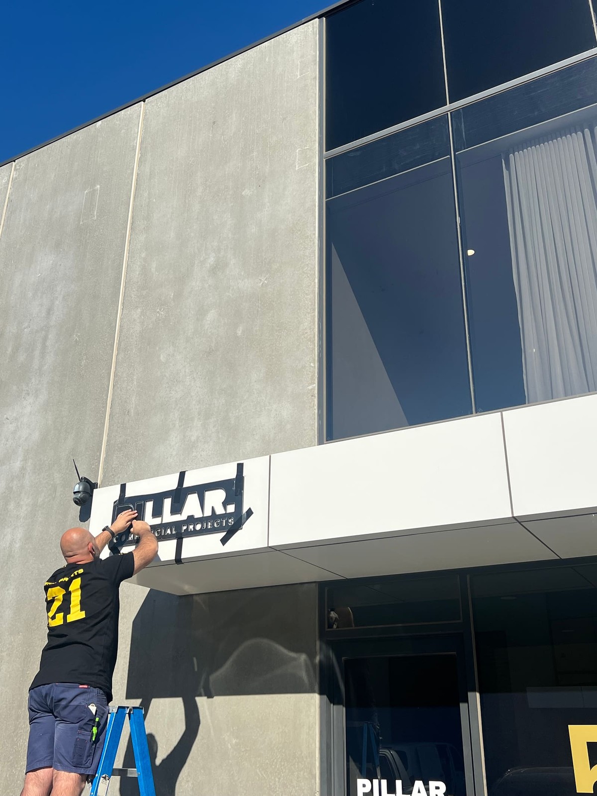 Pillar signage install at a shopfront
