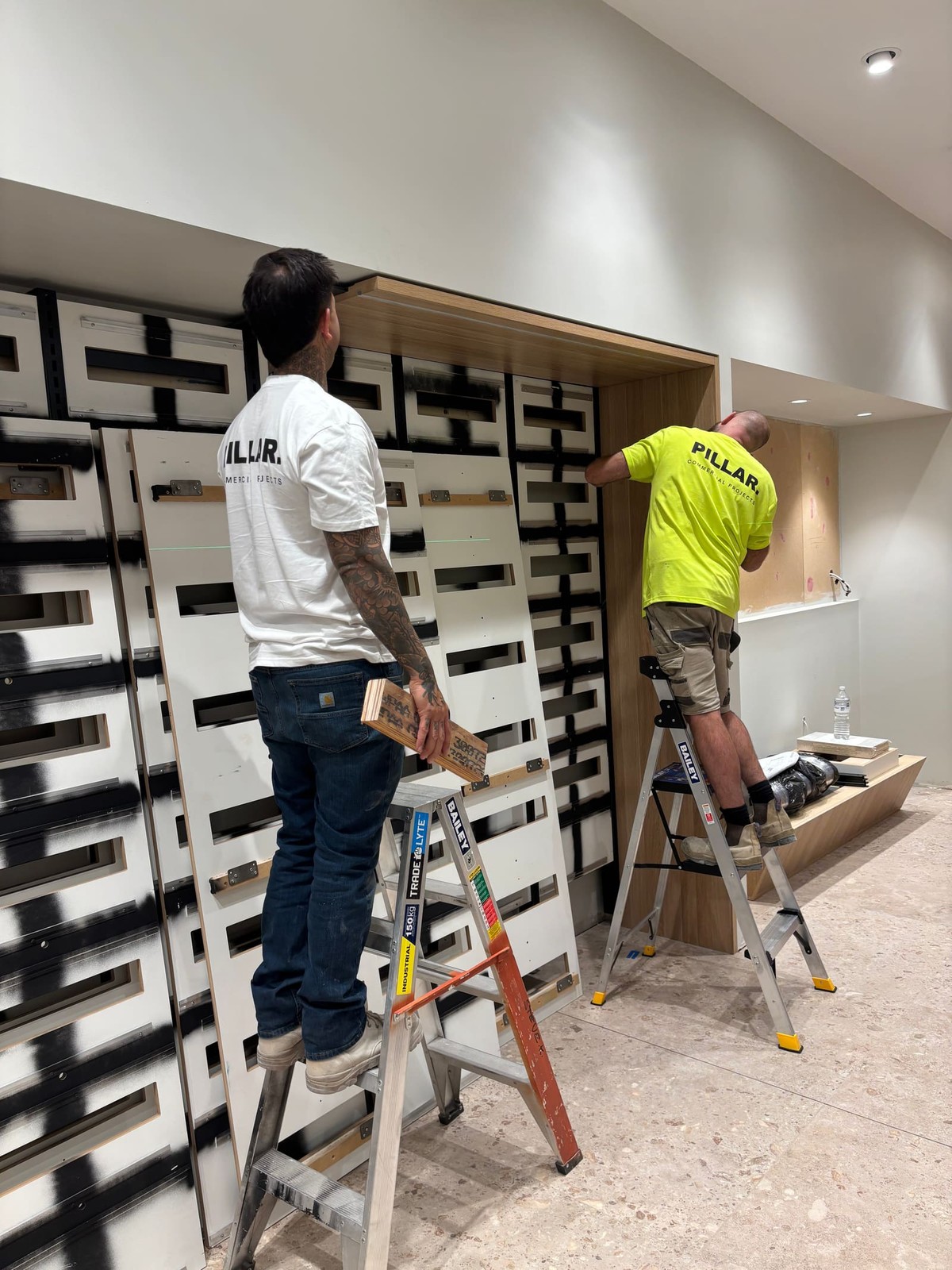 Pillar carpenter fixing off a feature wall