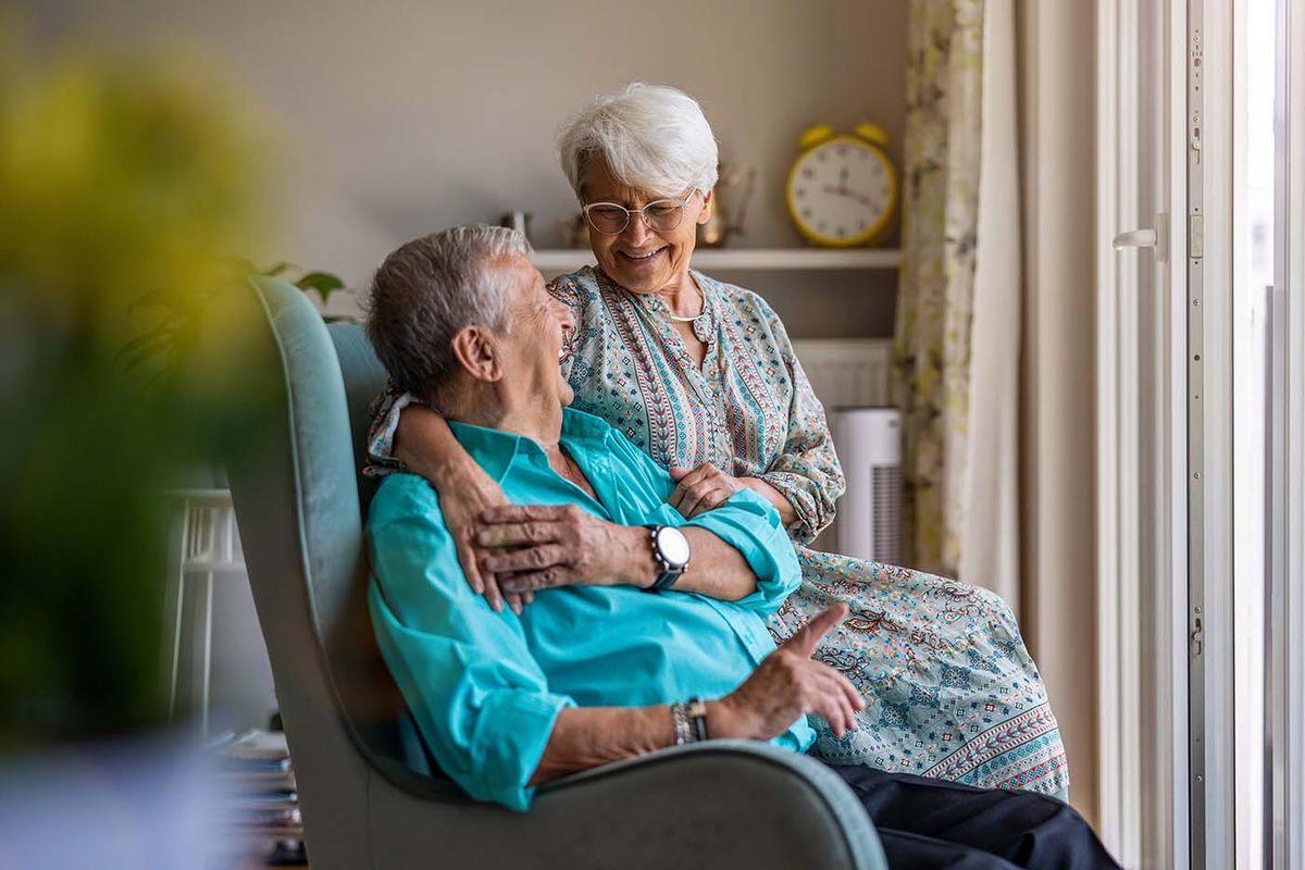 retired couple sitting together happily after moving