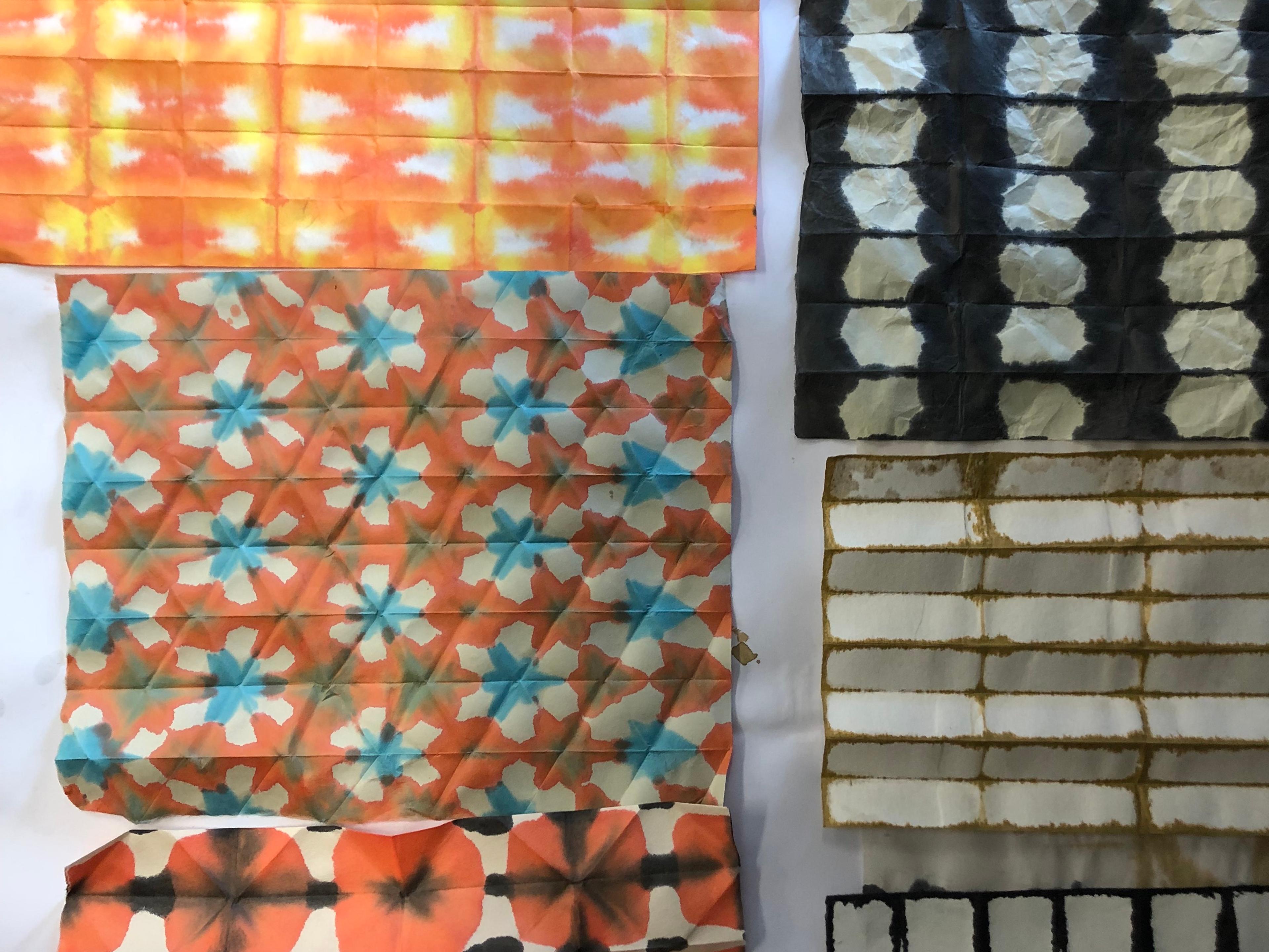 examples of marbling prints on Japanese paper; multiple colours and patterns